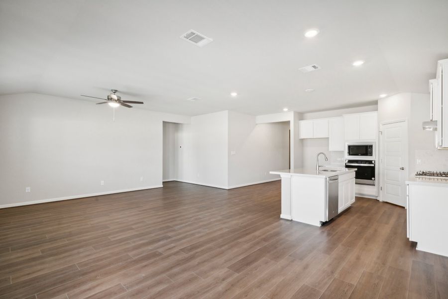 Kitchen and living room in the Fitzhugh floorplan in a Meritage Homes community.