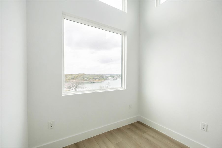 Unfurnished room featuring baseboards and light wood-type flooring