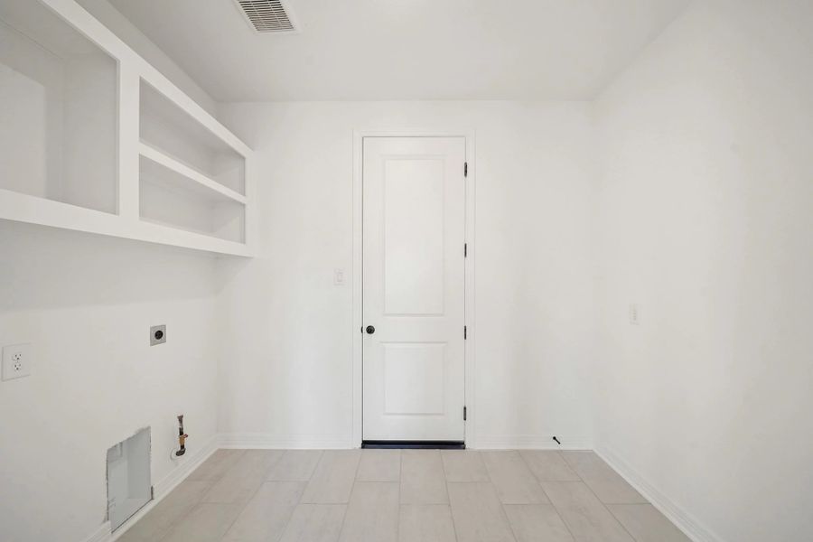 Utility room. "Note: Sample product photo. Actual exterior and interior selections may vary by homesite. Photo may be virtually staged"