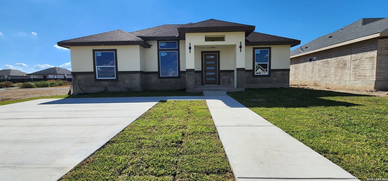 Front exterior of a new home in , Eagle Pass, TX, highlighting curb appeal (Image 9).