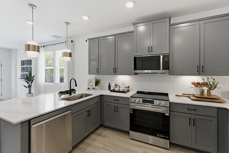 A kitchen with white cabinets.
