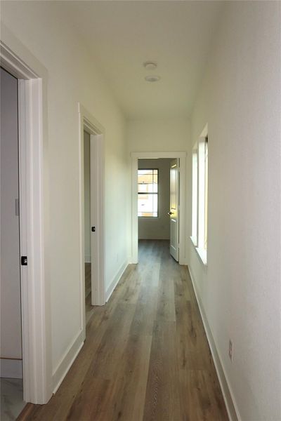 A hallway leads to the two additional bedrooms. A hallway leads to the two additional bedrooms.