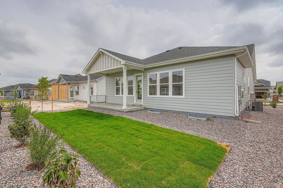 Front exterior of a new home in Hilltop 55+ at Inspiration 55s, Aurora, CO, highlighting curb appeal (Image 1).