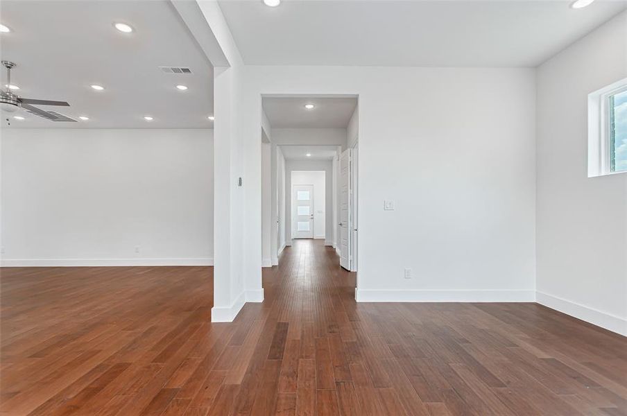 Spare room featuring dark wood-type flooring and ceiling fan