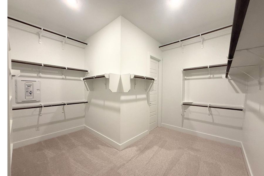 Ample shelving and hanging space defines this generously sized walk-in closet. Ample shelving and hanging space defines this generously sized walk-in closet.