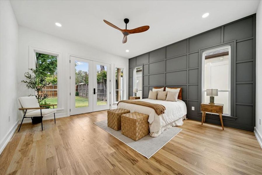 Bedroom featuring light hardwood flooring, access to exterior, and ceiling fan