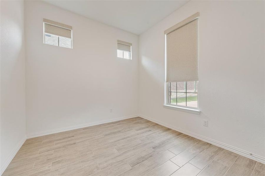Unfurnished room with healthy amount of natural light and light wood-style flooring Unfurnished room with healthy amount of natural light and light wood-style flooring