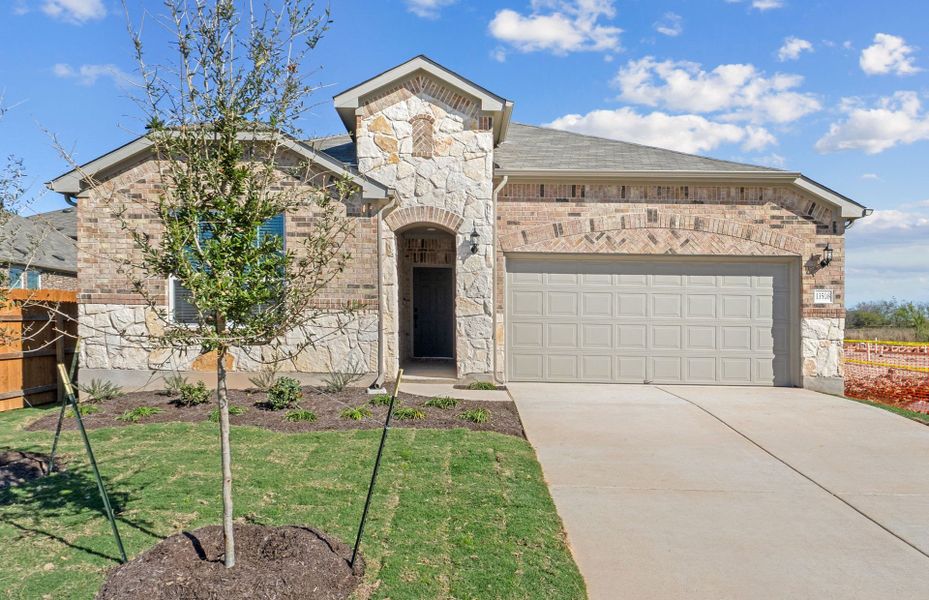 Front exterior of a new home in Lagos, Manor, TX, highlighting curb appeal (Image 18).