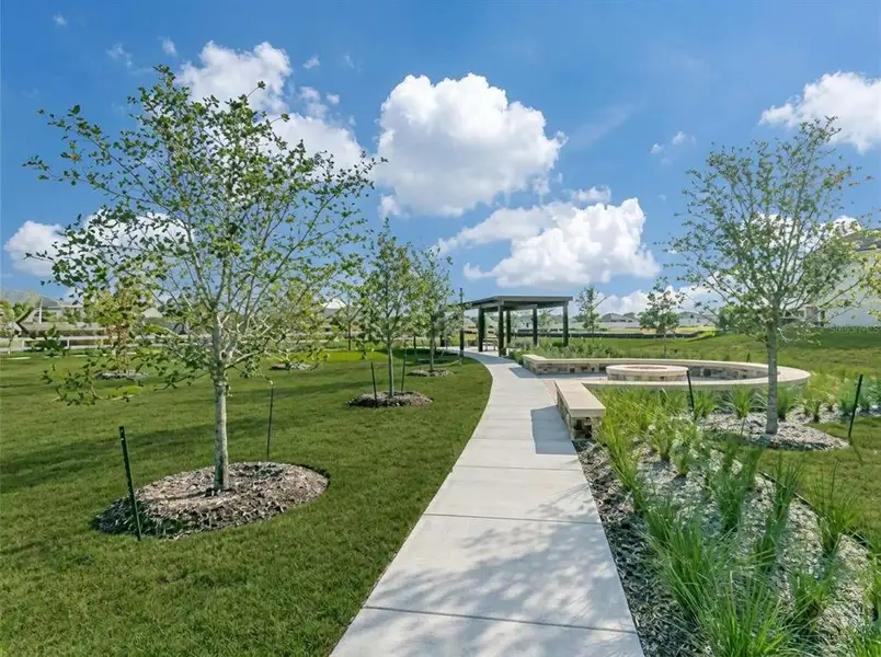 Lush green lawn with a winding concrete pathway