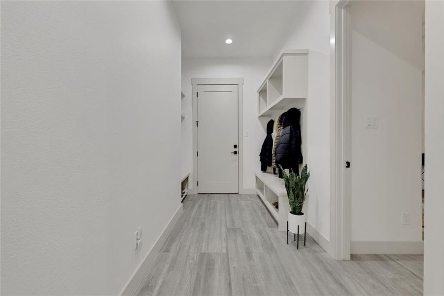 Hallway view leading to the garage. MUD area to hang your favorite jacket and get those muddy shoes off!