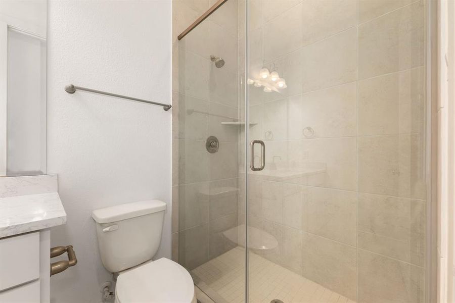 Step into comfort and style with the secondary bathroom, featuring a modern walk-in shower.