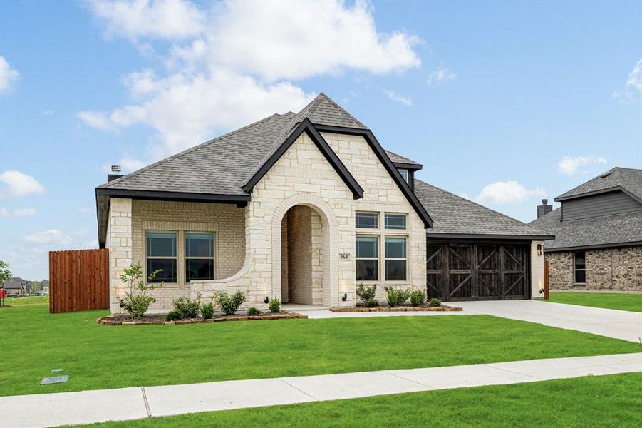 Front exterior of a new home in The Retreat at North Grove 60, Waxahachie, TX, highlighting curb appeal (Image 25). Front exterior of a new home in The Retreat at North Grove 60, Waxahachie, TX, highlighting curb appeal (Image 25).