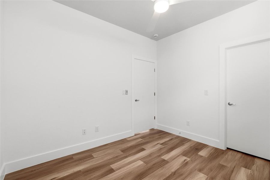 A second angle highlighting the walk-in closet—clean, efficient storage that makes this room work as more than just a bedroom.