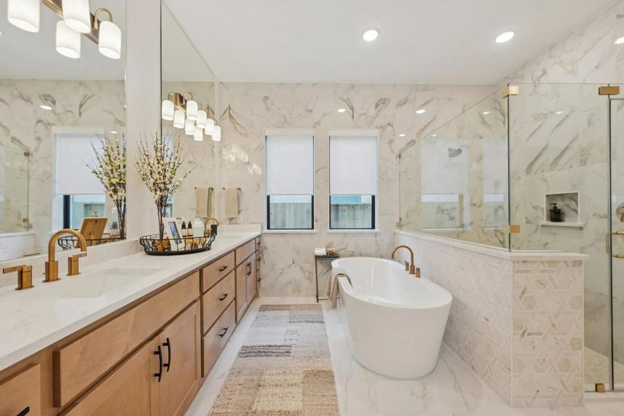 Sleek vanity with dual sinks complements a standalone tub, offering a tranquil retreat. Sleek vanity with dual sinks complements a standalone tub, offering a tranquil retreat.