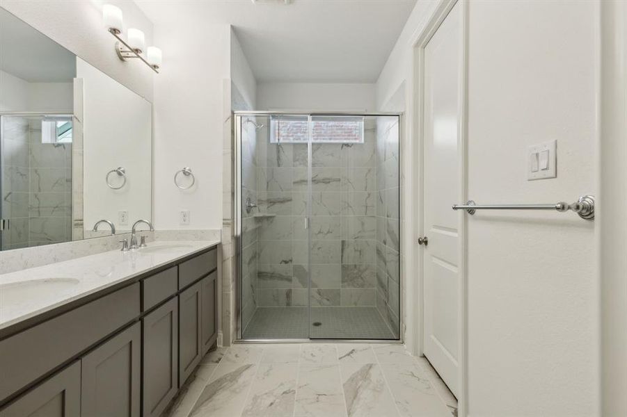 Bathroom with vanity and a shower with shower door