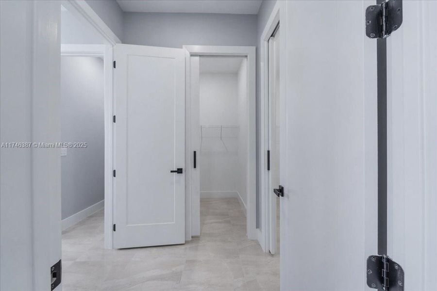 Hallway to primary bathroom