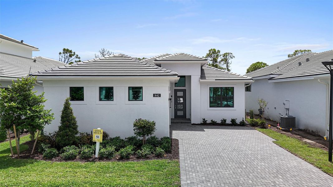 Front exterior of a new home in Cove Royale, Stuart, FL, highlighting curb appeal (Image 24). Front exterior of a new home in Cove Royale, Stuart, FL, highlighting curb appeal (Image 24).