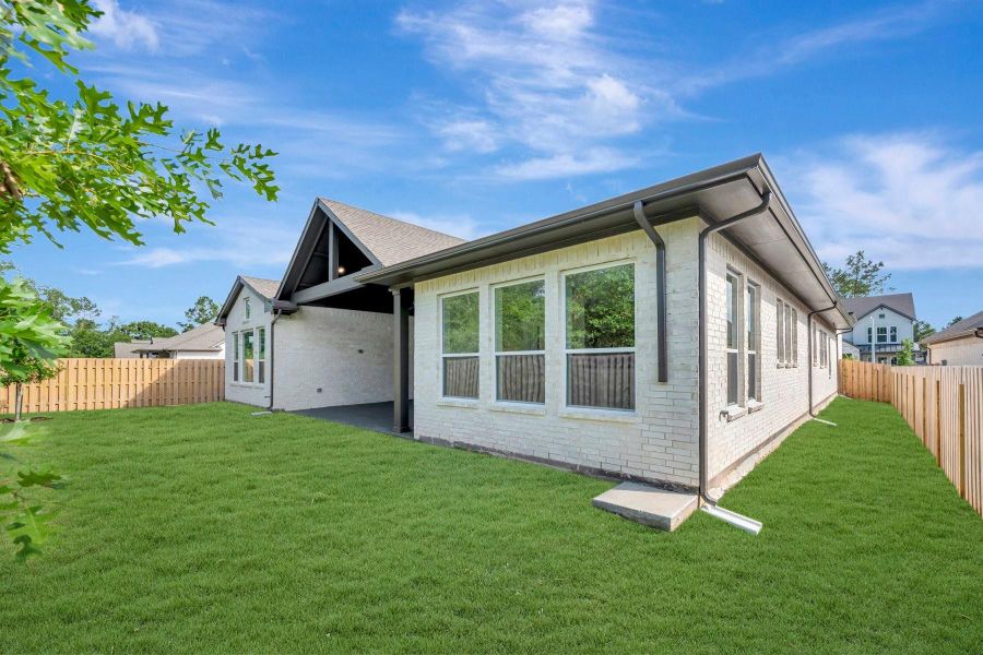 View of rear yard.  Fully fenced with sprinklers.