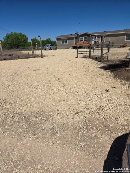 Front exterior of a new home in , La Pryor, TX, highlighting curb appeal (Image 6).