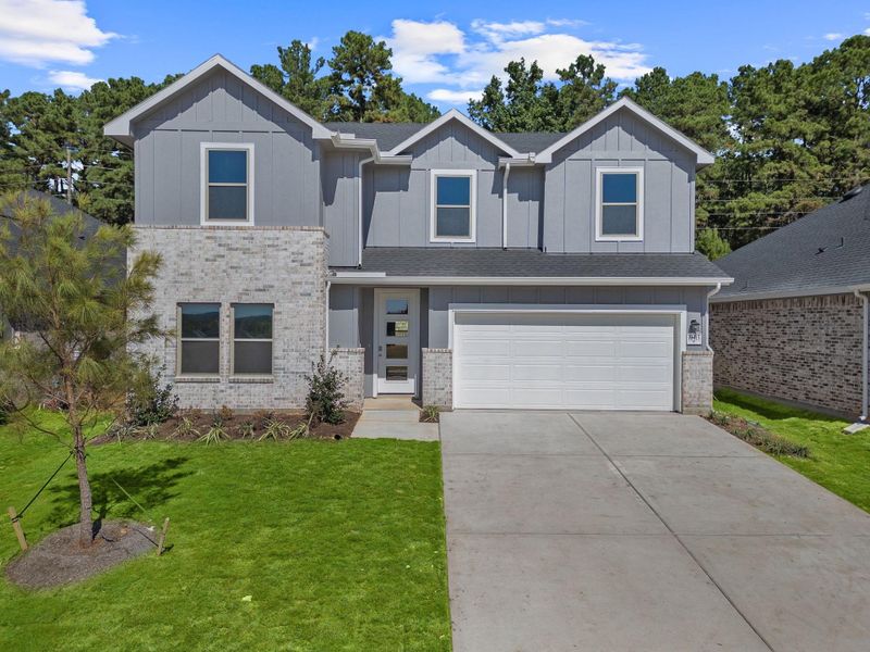 Front exterior of a new home in Westridge Cove, Conroe, TX, highlighting curb appeal (Image 2).