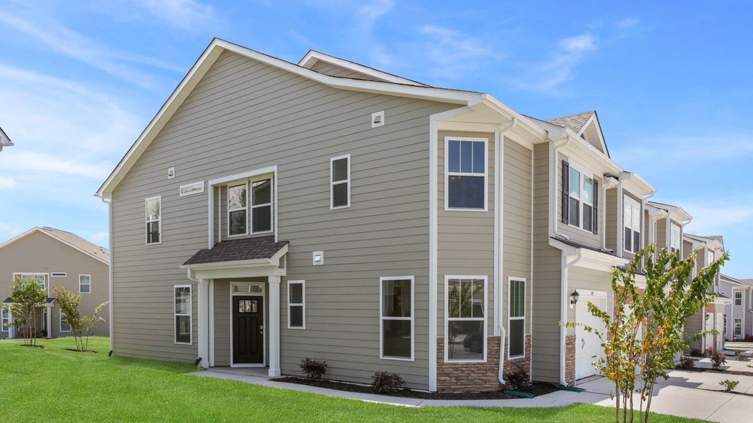 Front exterior of a new home in The Townes at Stonecrest, Hendersonville, NC, highlighting curb appeal (Image 2). Front exterior of a new home in The Townes at Stonecrest, Hendersonville, NC, highlighting curb appeal (Image 2).
