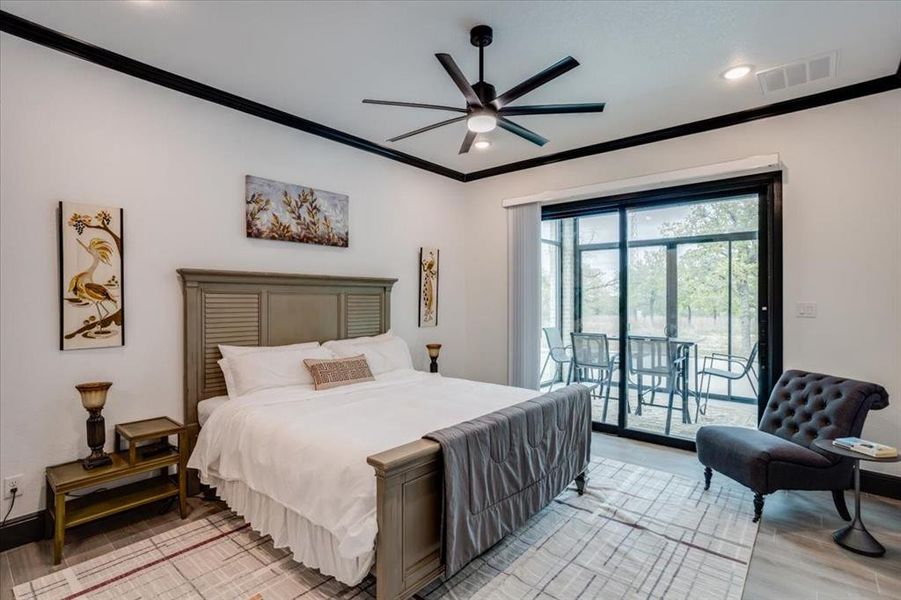 Bedroom with light  tile floors, crown molding, access to outside, a ceiling fan, and recessed lighting