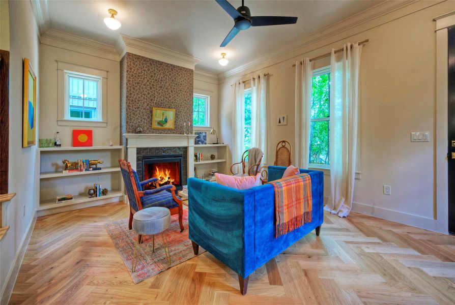 A comforting glow emanates from the fireplace, setting a warm ambiance in this thoughtfully appointed living area.