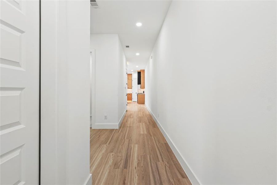 Hall with recessed lighting and light wood-style floors