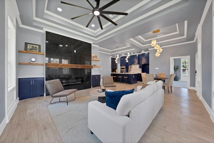 Spacious living area featuring a large fireplace with dark stone surround and a substantial wood mantel