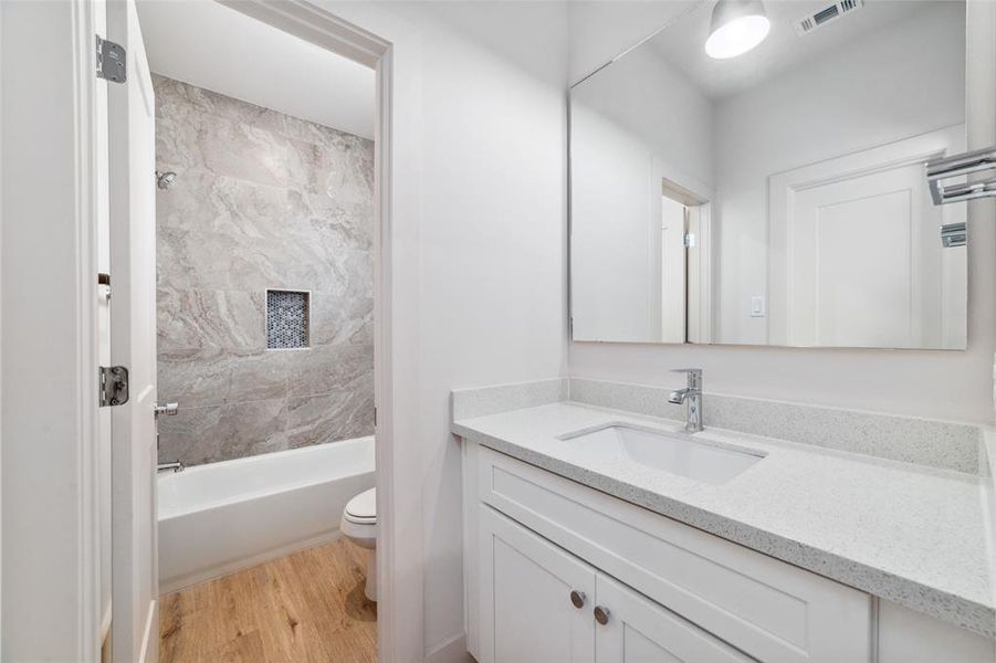 The Beautifully Appointed Secondary Bathroom Houses A Tub And Shower Combination. A Quartz Vanity Offers Style And Functionality. Seperate Toilet/ Shower Area Away From Sink Area