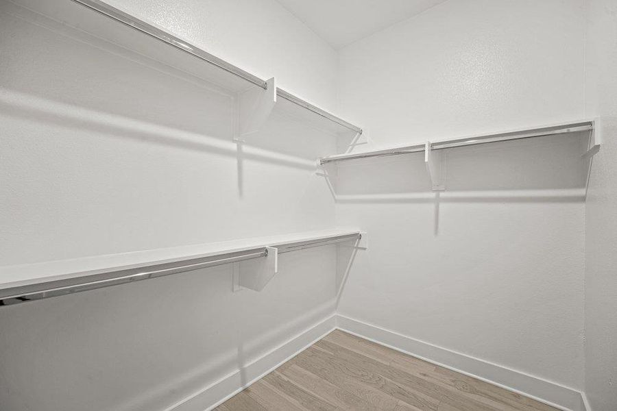 Large custom walk-in closet with extensive built-in shelving.