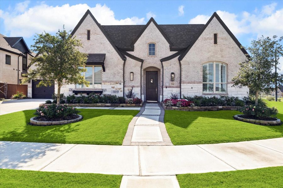 Front exterior of a new home in Elyson, Katy, TX, highlighting curb appeal (Image 18).