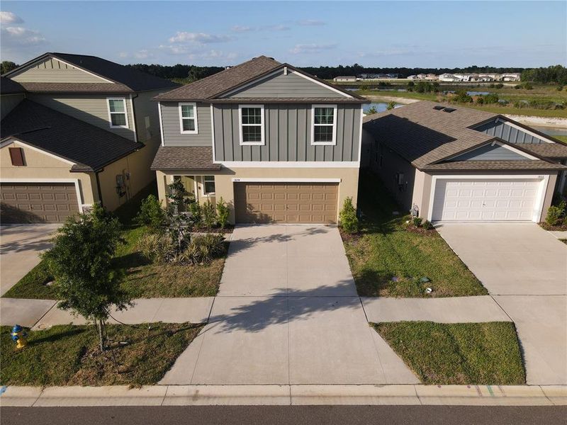 Front exterior of a new home in Two Rivers, Zephyrhills, FL, highlighting curb appeal (Image 24).