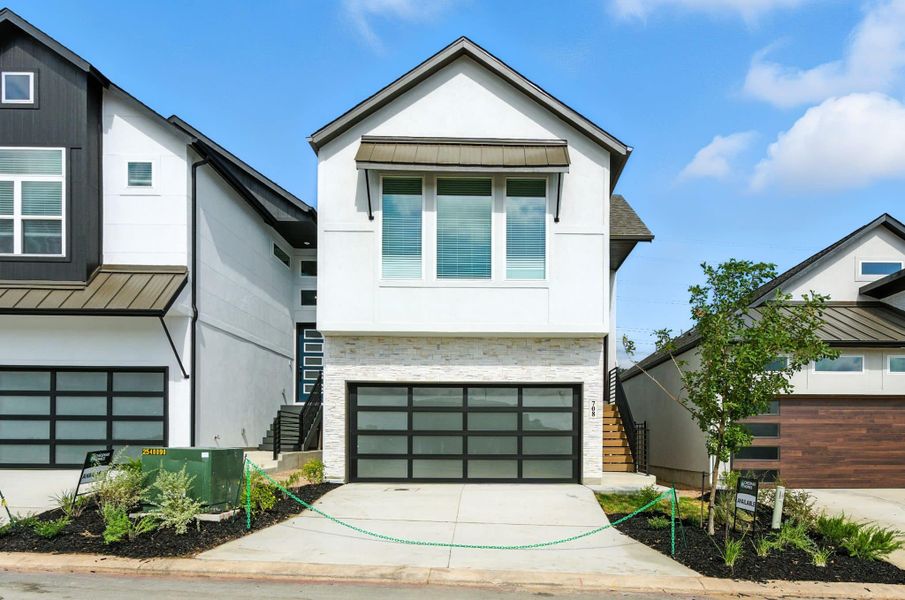 Front exterior of a new home in Centero at Stone Oak, San Antonio, TX, highlighting curb appeal (Image 18). Front exterior of a new home in Centero at Stone Oak, San Antonio, TX, highlighting curb appeal (Image 18).
