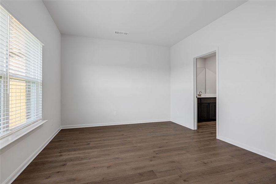 Spare room featuring dark wood-style floors
