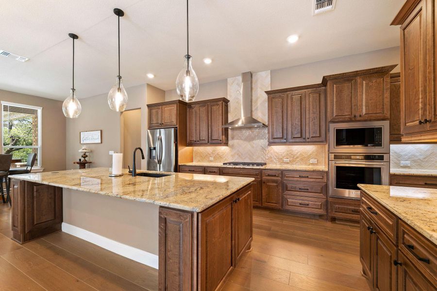 Culinary delights await in this gourmet kitchen featuring granite counters and state-of-the-art stainless steel appliances. Culinary delights await in this gourmet kitchen featuring granite counters and state-of-the-art stainless steel appliances.