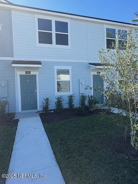 Exterior details and patio area of a home in Cordera Townhomes Express, St. Augustine (Image 3).