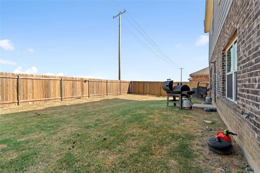 Fenced backyard with a patio area