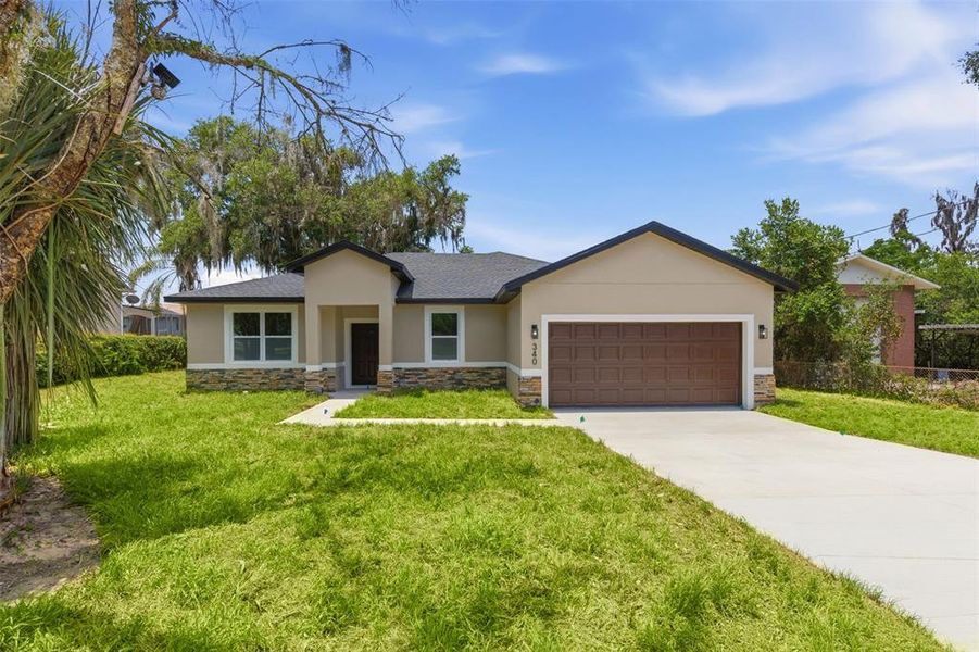 Front exterior of a new home in , Haines City, FL, highlighting curb appeal (Image 1). Front exterior of a new home in , Haines City, FL, highlighting curb appeal (Image 1).