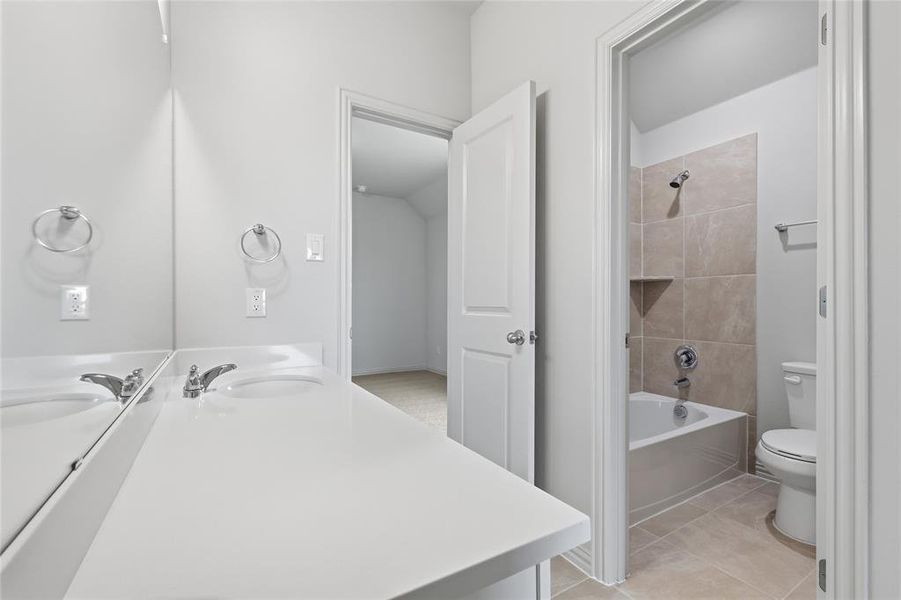 Double vanity with integrated sinks and white countertops