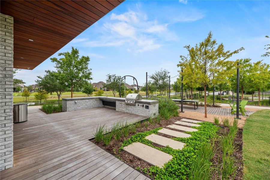 Host unforgettable gatherings and enjoy a day at the park with this beautifully designed outdoor pavilion, featuring a built-in grill, expansive deck, and inviting seating areas surrounded by lush green spaces.