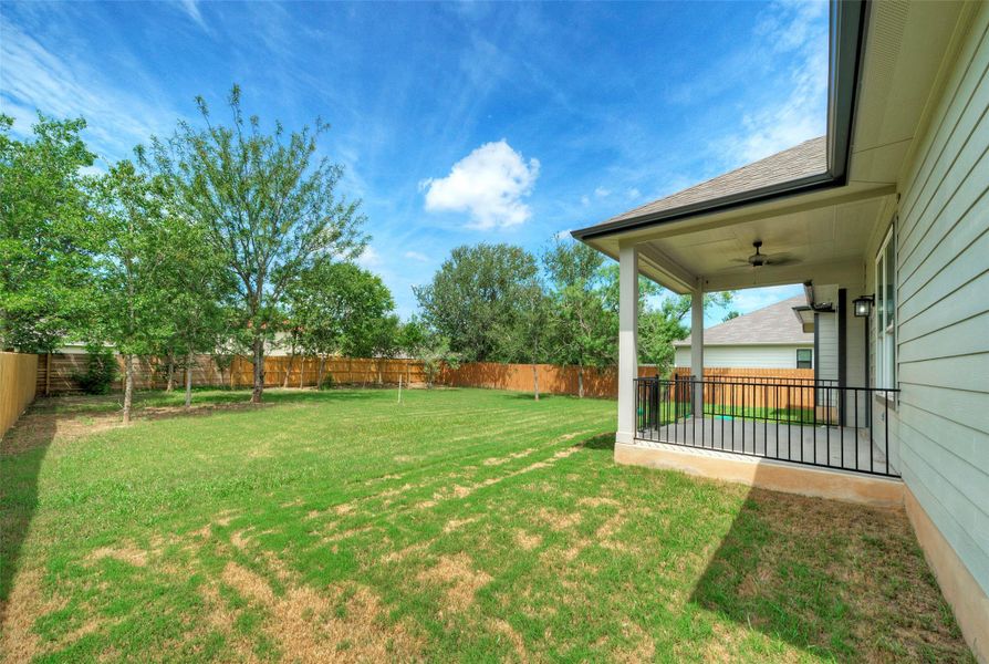 Fenced backyard featuring ceiling fan and a patio area Fenced backyard featuring ceiling fan and a patio area