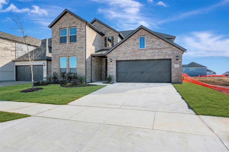 Front exterior of a new home in Lily Creek at Sutton Fields, Aubrey, TX, highlighting curb appeal (Image 2). Front exterior of a new home in Lily Creek at Sutton Fields, Aubrey, TX, highlighting curb appeal (Image 2).