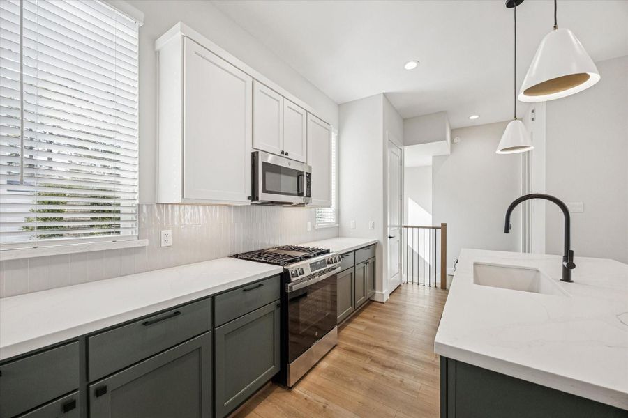 With its two-tone cabinetry, the kitchen brings warmth, color, and a layer of sophisticated contrast to the space.