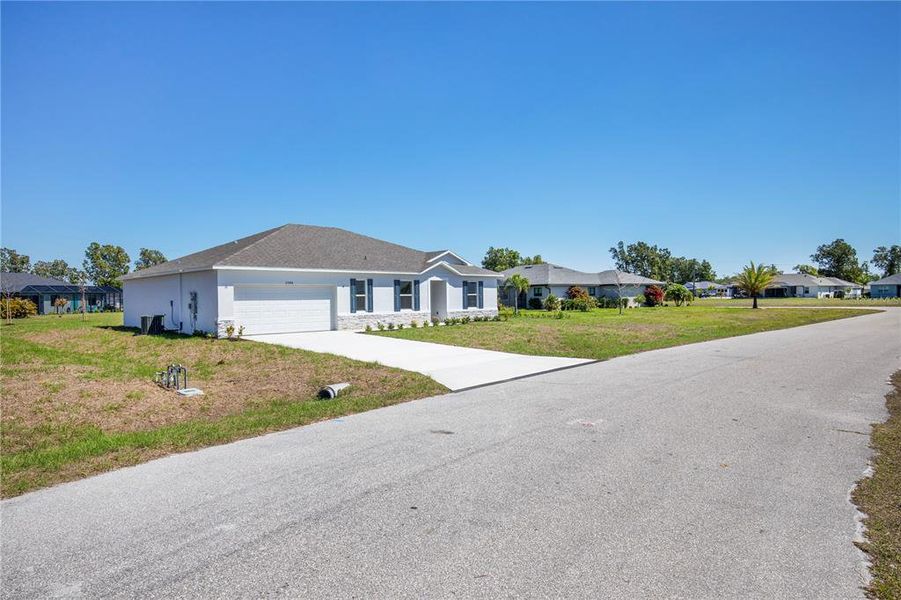 Front exterior of a new home in Burnt Store Village, Punta Gorda, FL, highlighting curb appeal (Image 22).