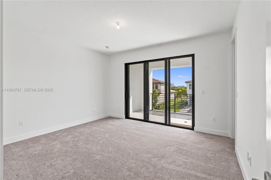 2nd bedroom with balcony and walk-in closet