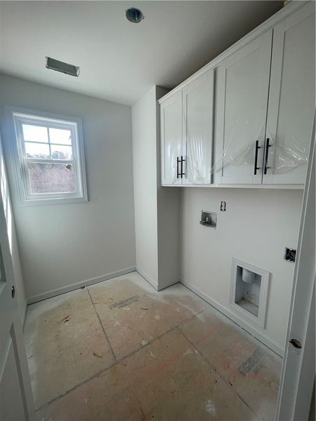 This bright utility space offers convenient laundr