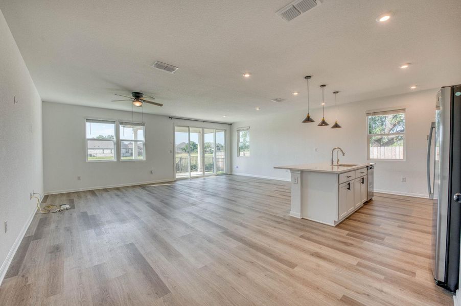 An open floorplan seamlessly connects the airy living area to the modern kitchen.