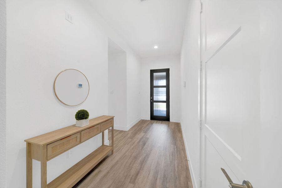 Enhanced features include elegant 8-foot doors and refined 5-inch wood trim throughout the home.