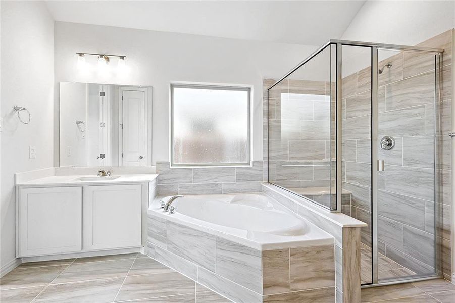 Bathroom with vanity, independent shower and bath, and tile patterned flooring